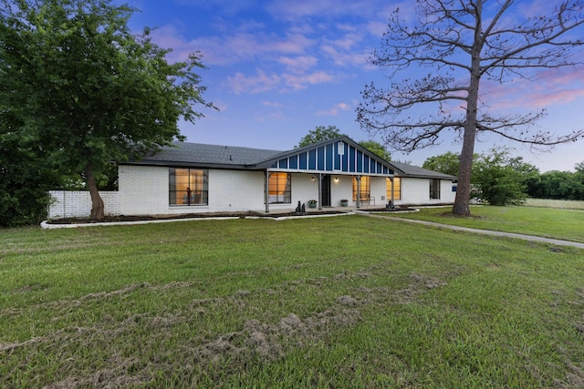 713 W Rosemary St, Quinlan, TX 75474 - mid-century home with brick siding, a front yard, covered porch, and board and batten siding