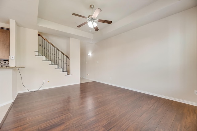4651 Penelope Ln, Plano, TX 75024 - unfurnished living room featuring ceiling fan, wood finished floors, a tray ceiling, stairway, and baseboards