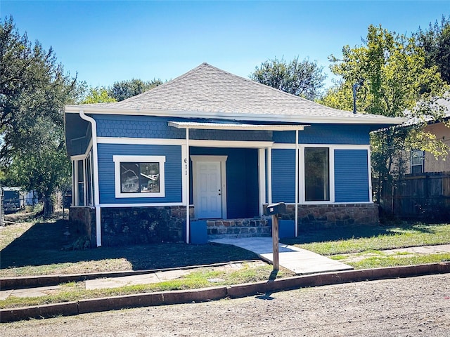 611 4th St, Mineral Wells, TX 76067 - view of front of property featuring stone siding, a shingled roof, and a porch
