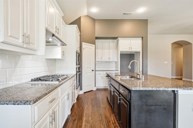9617 Rexford, Fort Worth, TX 76131 - kitchen with a sink, under cabinet range hood, appliances with stainless steel finishes, arched walkways, and white cabinetry