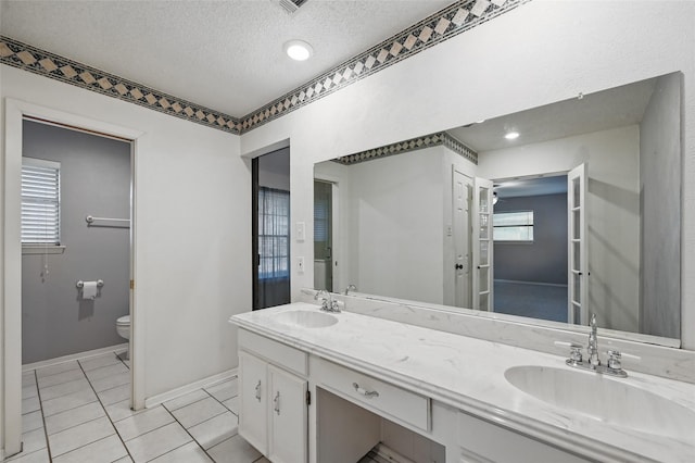 5702 Stage Line Ct, Arlington, TX 76017 - full bathroom with double vanity, a textured ceiling, and tile patterned floors
