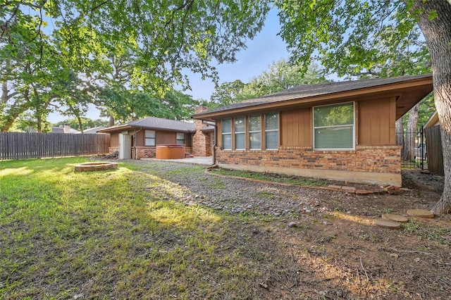5702 Stage Line Ct, Arlington, TX 76017 - view of front of house with a fenced backyard, brick siding, a fire pit, and board and batten siding