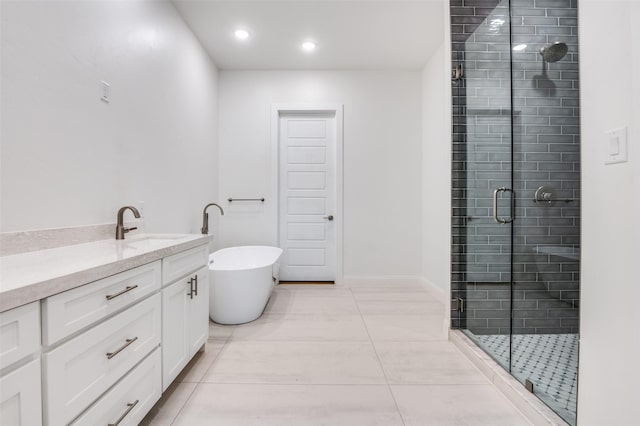 319 Bounding Main St, Gun Barrel City, TX 75156 - bathroom with a shower stall, a freestanding bath, vanity, tile patterned floors, and recessed lighting