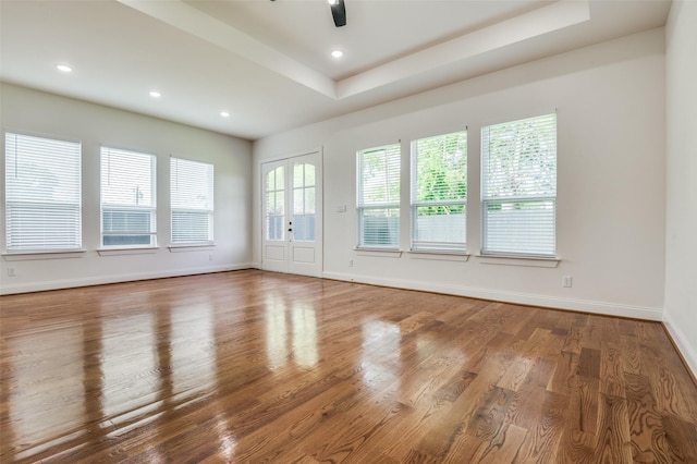 319 Bounding Main St, Gun Barrel City, TX 75156 - unfurnished room featuring a ceiling fan, wood finished floors, baseboards, recessed lighting, and a tray ceiling