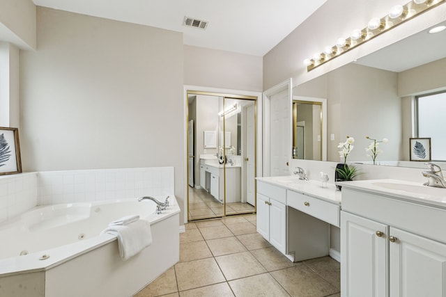 1702 Travis Ct, Allen, TX 75002 - bathroom featuring double vanity, tile patterned flooring, and a jetted tub