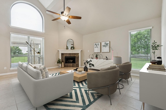 1702 Travis Ct, Allen, TX 75002 - living room with ceiling fan, light tile patterned floors, high vaulted ceiling, a tiled fireplace, and plenty of natural light
