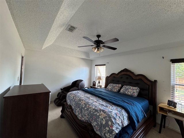 629 Yosemite Trl, Mesquite, TX 75149 - carpeted bedroom with a textured ceiling, a tray ceiling, and ceiling fan