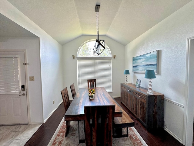 629 Yosemite Trl, Mesquite, TX 75149 - dining space with vaulted ceiling, wood finished floors, baseboards, and a chandelier