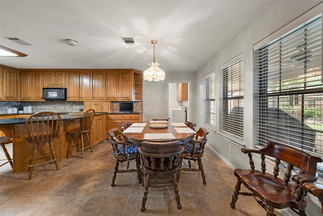 137 Thiele Rd, Lorena, TX 76655 - dining area featuring healthy amount of natural light, a chandelier, tile patterned floors, and baseboards