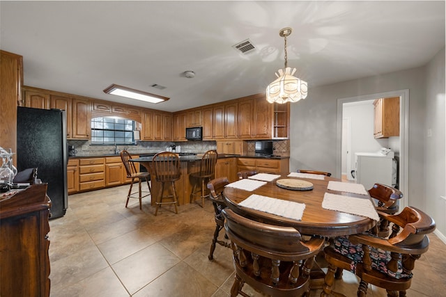 137 Thiele Rd, Lorena, TX 76655 - dining space featuring washer / dryer, a chandelier, and light tile patterned floors