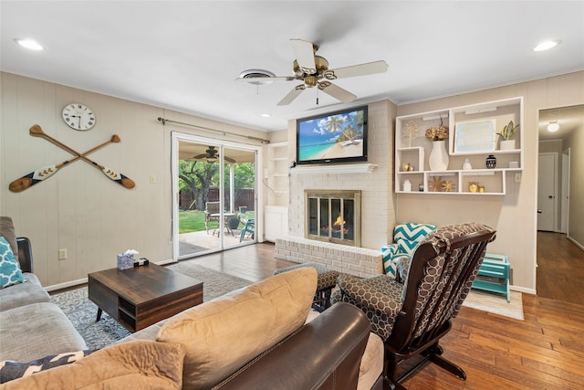 5 Scott Pl, Abilene, TX 79601 - living area with ceiling fan, wood-type flooring, a fireplace, baseboards, and ornamental molding