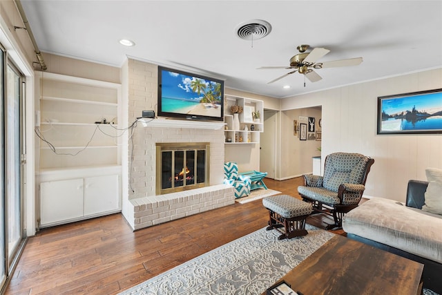 5 Scott Pl, Abilene, TX 79601 - living room with crown molding, wood finished floors, a ceiling fan, a brick fireplace, and recessed lighting