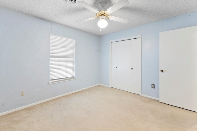 5 Scott Pl, Abilene, TX 79601 - unfurnished bedroom featuring carpet flooring, a closet, a textured ceiling, baseboards, and a ceiling fan