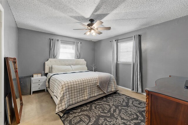 5 Scott Pl, Abilene, TX 79601 - bedroom featuring light carpet, ceiling fan, and a textured ceiling