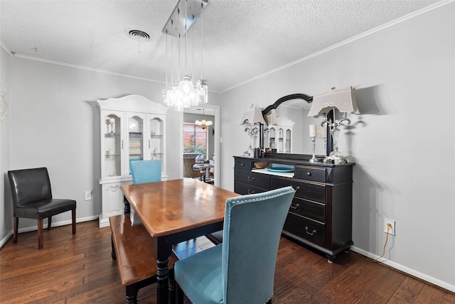 5 Scott Pl, Abilene, TX 79601 - dining room with a textured ceiling, a chandelier, dark wood-style flooring, crown molding, and baseboards