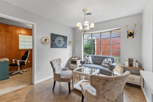 5 Scott Pl, Abilene, TX 79601 - tiled living room featuring a chandelier, a textured ceiling, carpet flooring, and baseboards