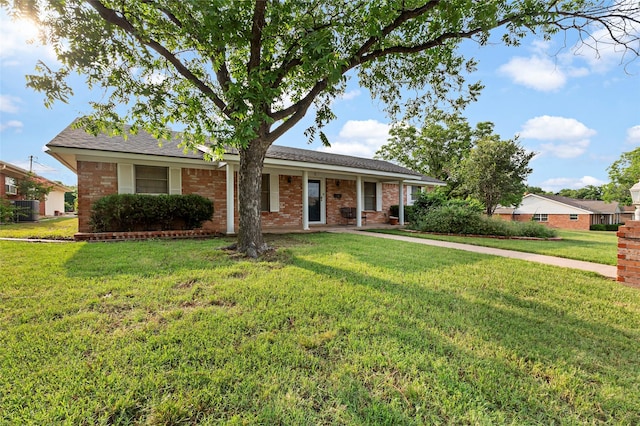 5 Scott Pl, Abilene, TX 79601 - ranch-style home with a front yard, brick siding, cooling unit, and roof with shingles