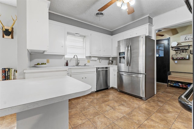 5 Scott Pl, Abilene, TX 79601 - kitchen with stainless steel appliances, a peninsula, light countertops, a sink, and white cabinetry
