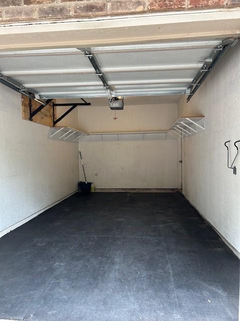 7340 Skillman St Unit 1113, Dallas, TX 75231 - garage featuring a garage door opener