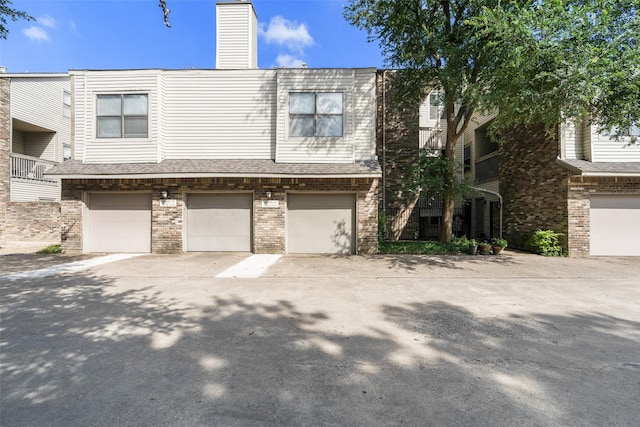 7340 Skillman St Unit 1113, Dallas, TX 75231 - multi unit property with brick siding, a garage, concrete driveway, and a chimney