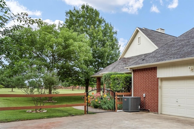 1755 County Road 362, Melissa, TX 75454 - view of side of home featuring central air condition unit, a shingled roof, brick siding, concrete driveway, and a gate