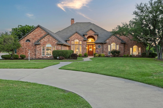 220 Sunray Ln, Sunnyvale, TX 75182 - view of front of property featuring a lawn, a chimney, brick siding, and roof with shingles