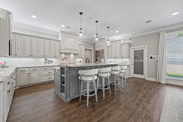 220 Sunray Ln, Sunnyvale, TX 75182 - kitchen featuring stainless steel refrigerator with ice dispenser, premium range hood, crown molding, a kitchen island with sink, and tasteful backsplash