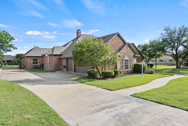 220 Sunray Ln, Sunnyvale, TX 75182 - view of front of house with brick siding, driveway, a front lawn, and a garage