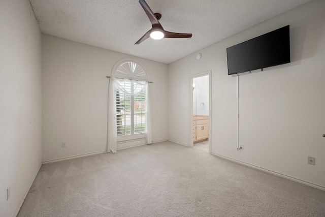 6604 Nantucket Ln, Arlington, TX 76001 - unfurnished bedroom with light carpet, a textured ceiling, ensuite bath, ceiling fan, and baseboards