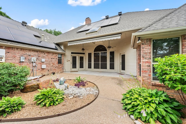 6604 Nantucket Ln, Arlington, TX 76001 - back of house featuring solar panels, brick siding, french doors, a patio, and a shingled roof
