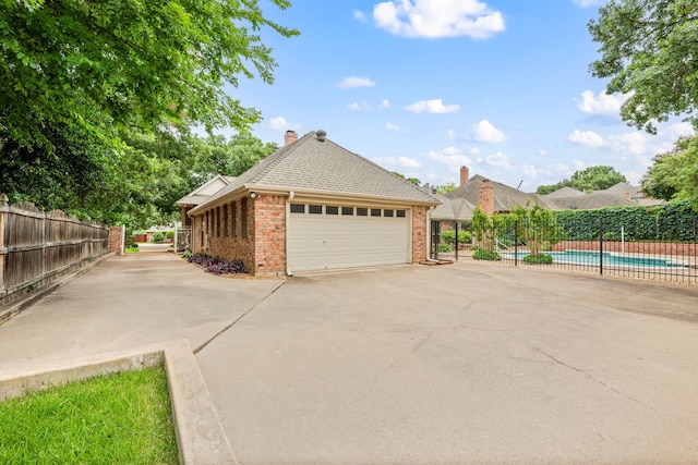 6604 Nantucket Ln, Arlington, TX 76001 - view of property exterior featuring brick siding, a garage, concrete driveway, a chimney, and a shingled roof