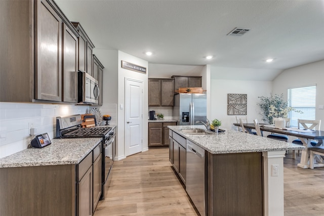 708 Cool Canyon Trl, Princeton, TX 75407 - kitchen with dishwasher, a sink, light wood-type flooring, an island with sink, and open floor plan