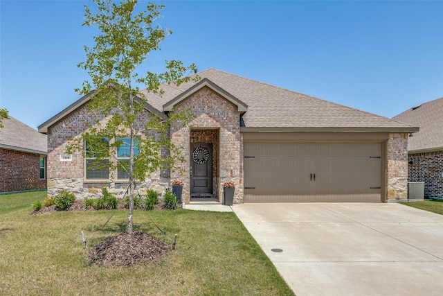 708 Cool Canyon Trl, Princeton, TX 75407 - view of front of home with a garage, a shingled roof, a front lawn, and driveway
