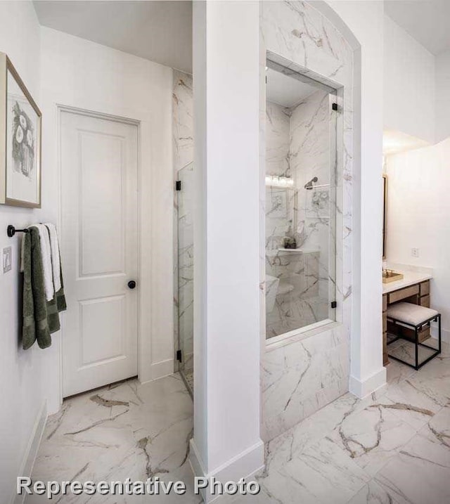 2507 Miranda Ln, Rockwall, TX 75087 - bathroom featuring marble finish floors, a marble finish shower, vanity, and baseboards