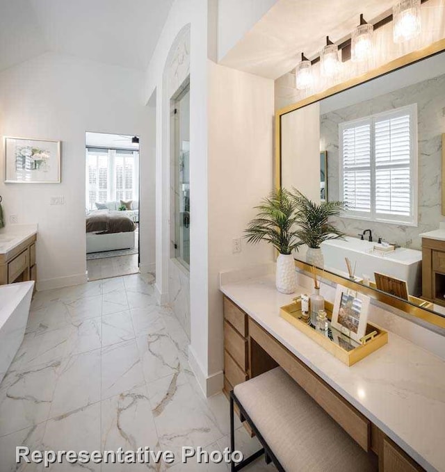 2507 Miranda Ln, Rockwall, TX 75087 - full bathroom featuring a tub to relax in, healthy amount of natural light, ensuite bathroom, baseboards, and lofted ceiling