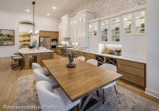 2507 Miranda Ln, Rockwall, TX 75087 - dining space with light wood-type flooring, a chandelier, baseboards, and recessed lighting