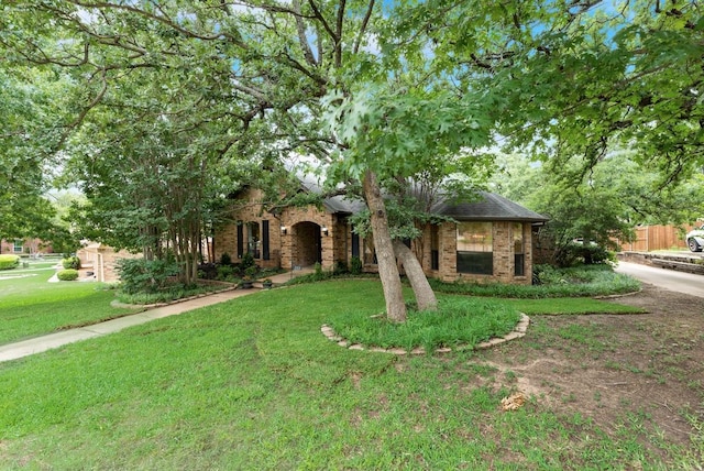 233 Shields Dr, Trophy Club, TX 76262 - view of property hidden behind natural elements with a front lawn, brick siding, and roof with shingles