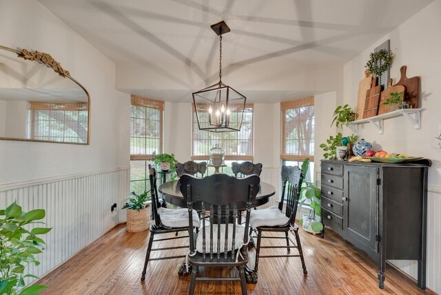 233 Shields Dr, Trophy Club, TX 76262 - dining area with a chandelier, wood finished floors, and wainscoting