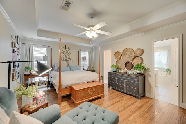 233 Shields Dr, Trophy Club, TX 76262 - bedroom with a tray ceiling, light wood-type flooring, ornamental molding, ensuite bath, and ceiling fan