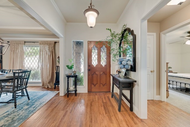 233 Shields Dr, Trophy Club, TX 76262 - entrance foyer featuring light wood finished floors, healthy amount of natural light, a ceiling fan, crown molding, and baseboards