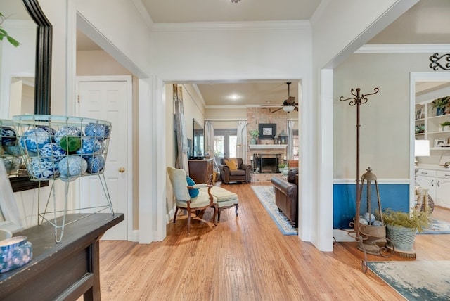 233 Shields Dr, Trophy Club, TX 76262 - entryway with a ceiling fan, light wood-style floors, ornamental molding, a fireplace, and baseboards