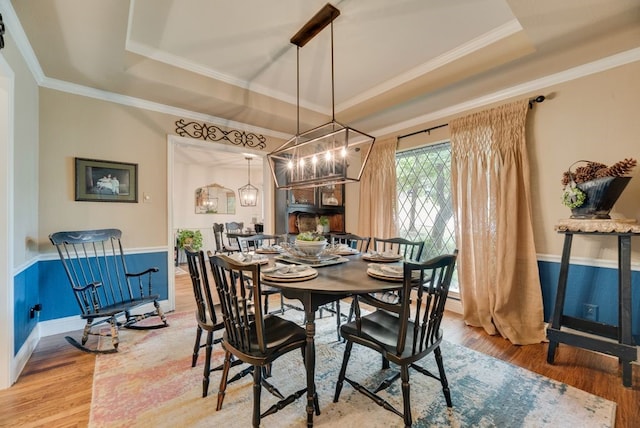233 Shields Dr, Trophy Club, TX 76262 - dining space featuring a raised ceiling, wood finished floors, ornamental molding, and a chandelier