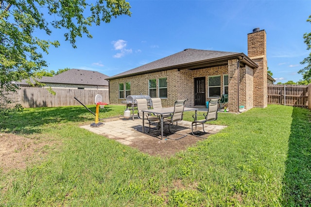 101 Pinkston St, Terrell, TX 75160 - back of house with a chimney, a patio, brick siding, and a shingled roof