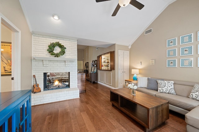 3907 Meadow Dr, Grapevine, TX 76051 - living area with vaulted ceiling, crown molding, ceiling fan, wood finished floors, and a brick fireplace