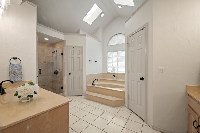 3907 Meadow Dr, Grapevine, TX 76051 - bathroom featuring a skylight, vanity, a shower stall, a garden tub, and a textured wall