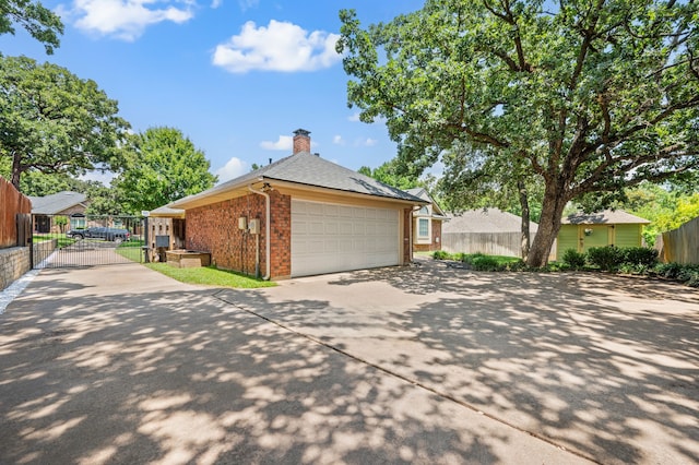3907 Meadow Dr, Grapevine, TX 76051 - view of home's exterior with brick siding, driveway, a gate, an attached garage, and a chimney