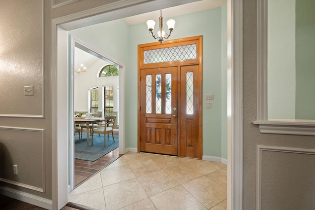 3907 Meadow Dr, Grapevine, TX 76051 - entryway with a chandelier, baseboards, and light tile patterned flooring