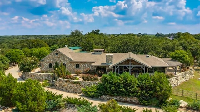 242 Bishop Dr, Weatherford, TX 76088 - rear view of house featuring a wooded view and stone siding