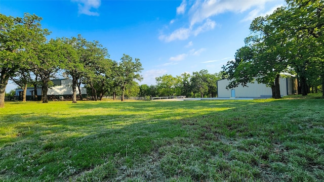 242 Bishop Dr, Weatherford, TX 76088 - view of green lawn featuring an outbuilding and a pole building