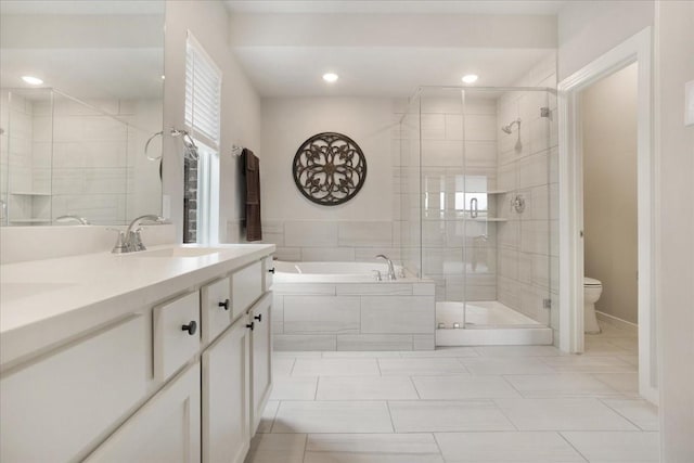 3913 Southbend Ct, Denison, TX 75020 - bathroom featuring a shower stall, a bath, toilet, double vanity, and recessed lighting